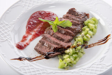 fried piece of meat served with sauce