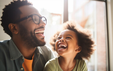 Black african american dark-skinned handsome happy father having fun with cute little daughter. Dad spending time with kid together