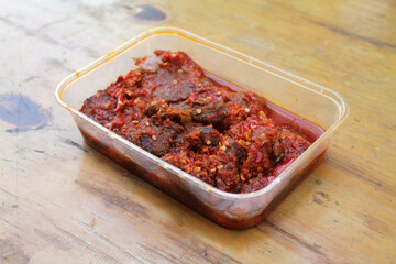 Dendeng Balado or Dendeng Batokok, and is a speciality from Padang, West Sumatra, Indonesia. Made from beef which is thinly cut then dried and fried before adding chillies and other ingredients
