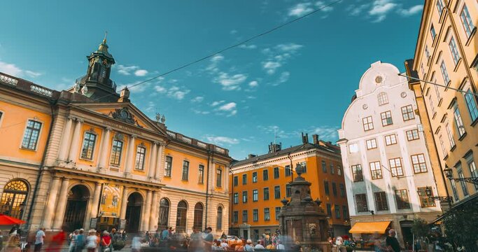 Stockholm, Sweden. Tourists People Walking Near Nobel Museum And Point 0 On Stortorget Square In Summy Summer Day. Famous Popular Place In Old Town Gamla Stan. Travel to Sweden.