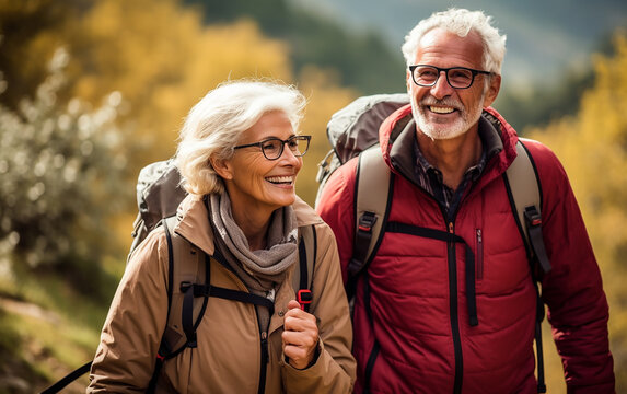 Elderly happy couple hiking outdoors. Fitness walking and forest travel journey. Active senior person concept