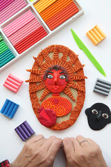 Plasticine modelling clay. Portrait of red man. Home developing activities, creative idea, hobby. Plasticine sculpture. Sculpts from plasticine modelling clay. Art