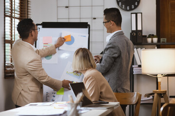 Group of business team working with analysis financial data visualization tech for marketing strategy, Businesswoman accountant or financial report graph at desk in corporate office. 