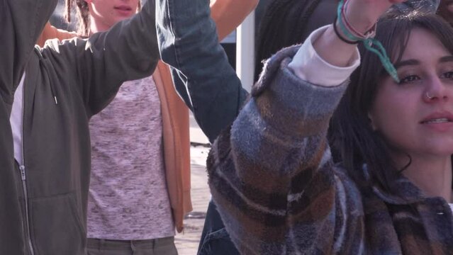 Student March: Voices Raised in Protest - Handheld footage of diverse university students marching, chanting, and raising fists in a passionate demonstration on city streets.
