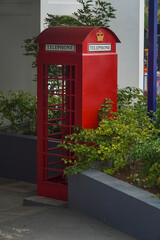 Fototapeta premium Classic red British telephone box in the garden