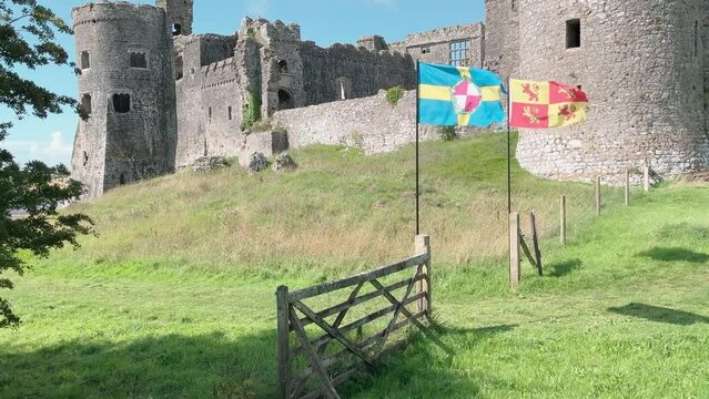 View of Carew Castle with flags of Pembrokeshire and Owain Glyn Dwr flying Pembroke Pembrokeshire Wales