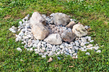Small cairn of natural stones arranged on grass