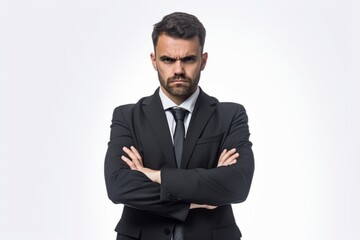 Portrait of a pensive business man with crossed arms looking at camera isolated on a white background