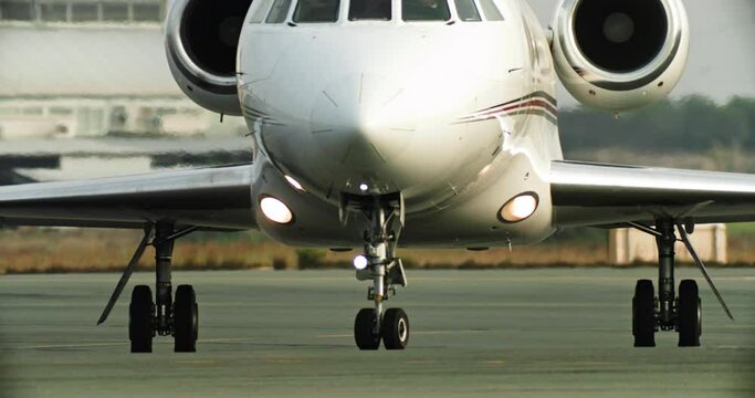 A private business jet is going for take off at the airport. The plane moves to the runway. High quality 4k footage