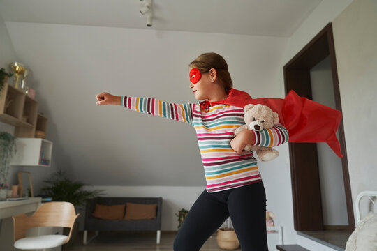 Caucasian girl playing a role of superhero costume