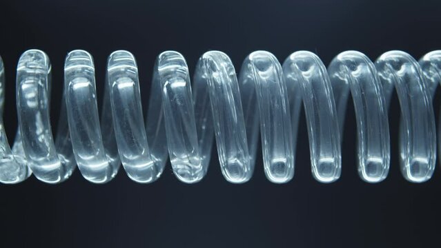 The flask is a tube with a spiral inside. Chemical reactions. Scientific experiment. Green liquid flows in a spiral into the flask.
