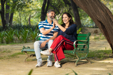Indian couple laughing and giving happy expression.