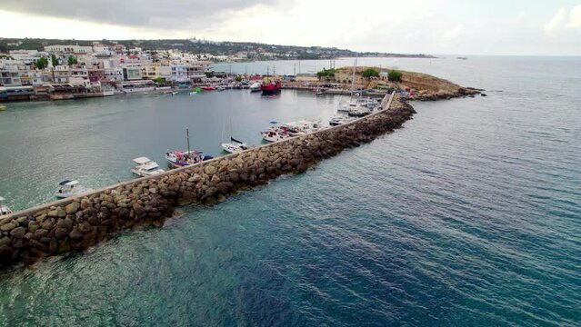 The drone flies in slow motion over the port of Hersonissos towards the city.