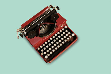 Vintage typewriter on green flat background