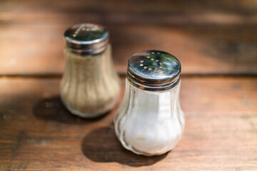 Salt and pepper dispensers on table