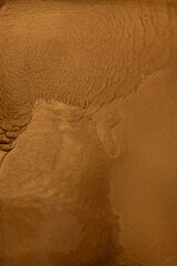 Golden liquid texture. Seethe fluid. Yellow red black white background.