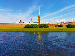 Summer landscape with the Peter and Paul fortress and water of channel in St. Petersburg, Russia. Historical ancient building of Russian architecture. Travel destination for vacation concept.