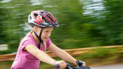 Fototapeta na wymiar Young girl riding a bicycle