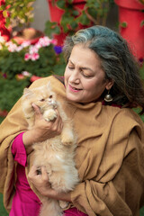 Indian senior woman with cat at home
