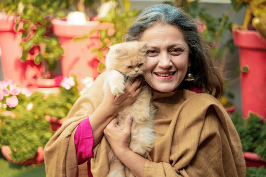 Indian senior woman with cat at home