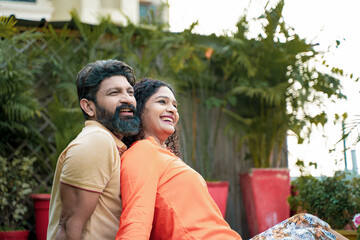 Naklejka premium Young indian couple laughing,funny and spending time to each other, at park.