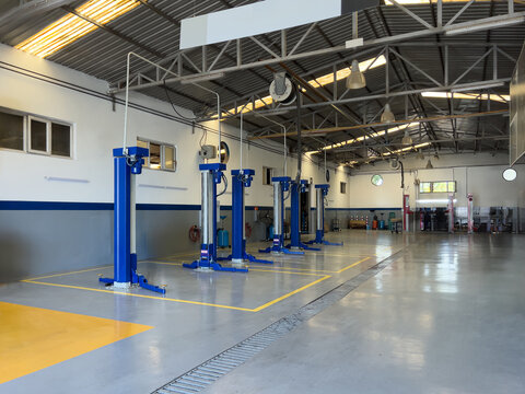 Empty car repair station with blue hydraulic lift