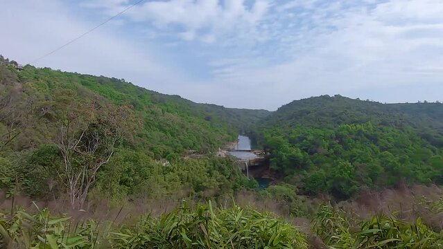 dense green forests with pristine waterfall at day from flat angle video is taken at Krang Suri Falls meghalaya north east india.