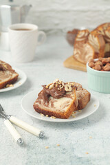A piece of marble biscuit with chocolate cream and nuts