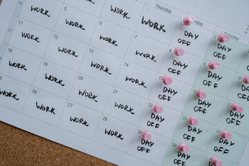 4 day work week printed calendar with pink pins on three days off in week weekend days four day...