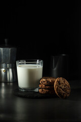 A glass with milk and chocolate cookies