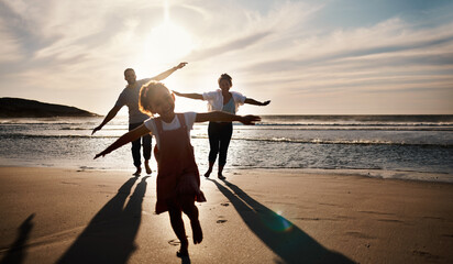 Family, running and freedom on beach with sunset, shadow and fun together, games and bonding on...