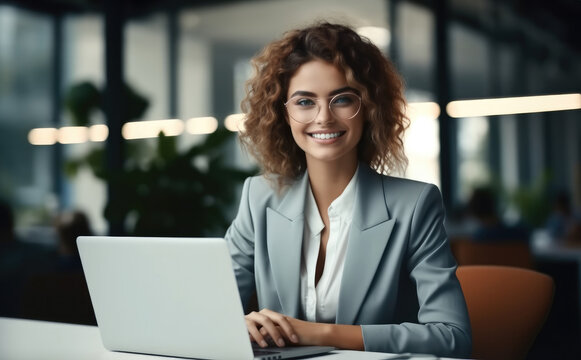 Portrait of cheerful businesswoman smiling at workplace.