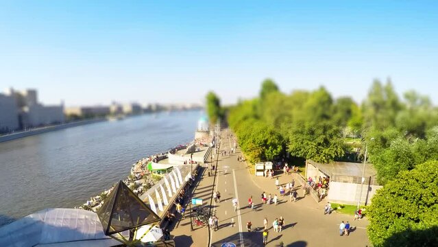 People walking in city park. Aerial time lapse with tilt shift effect