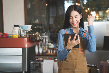 Asian Coffee Shop Owner Accepts a Pre-Order on a Tablet Happy  Smiling to the Customer in a Cozy...