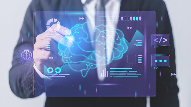 Businessman drawing a holographic projection of a human brain on a touch screen interface
