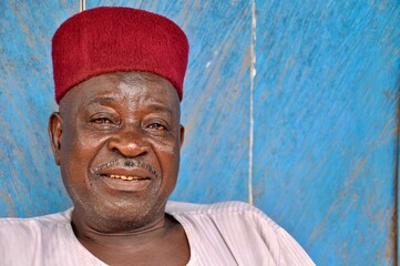 Portrait of a smiling Muslim man with red fez