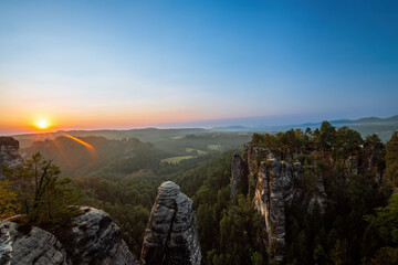 the sun rises at the elbsandsteingebirge