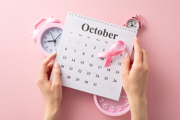 Remember the cause this World Breast Cancer Awareness Month. Top view photo of hands with calendar,...