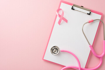 Conceptual breast cancer awareness composition. Top view of medical poll clipboard, pink ribbon...