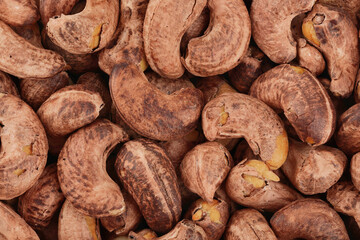 cashew nuts heap background with shell. Top view. Flat lay