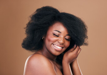 Natural, black woman and hair care with beauty, smile and luxury on a brown studio background....
