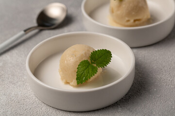 Lemon sorbet with mint leaf, refreshing ice cream, two servings of one ball