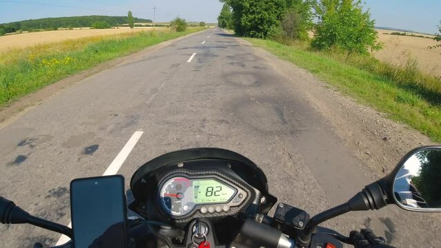 Motorcycle riding on the asphalt road, moto traveling in the summer, first person point of view, pov