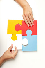 Four puzzle pieces on white background. World autism day concept