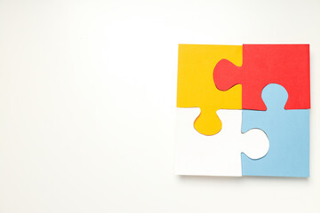 Four puzzle pieces on white background, place for text. World autism day concept