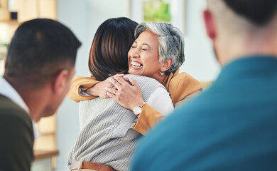 Business people, women and hug in group therapy in office, care or bonding for mental health with...