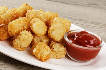 Close up of delicious Tater Tots on a wooden background