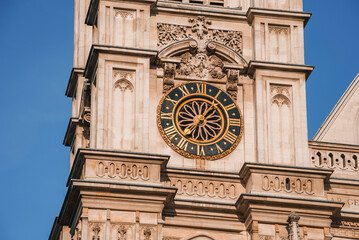 Closeup shot of Clock Tower in London. Famous Elizabeth Monument with blue sky in background. Brown...