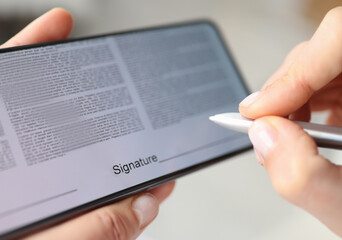 Person puts signature with stylus on contract screen of smartphone. Signature applications concept