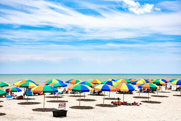 Fototapeta na wymiar Colorful umbrellas for rent on Cocoa Beach, Florida near Cape Canaveral in Brevard County also known as the Space Coast. 